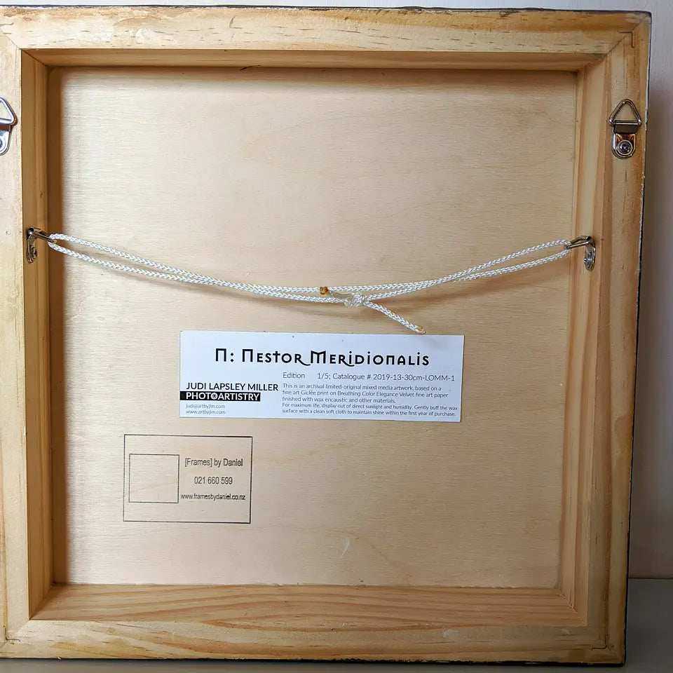 Back view of artwork showing wooden cradleboard and hanging hardware