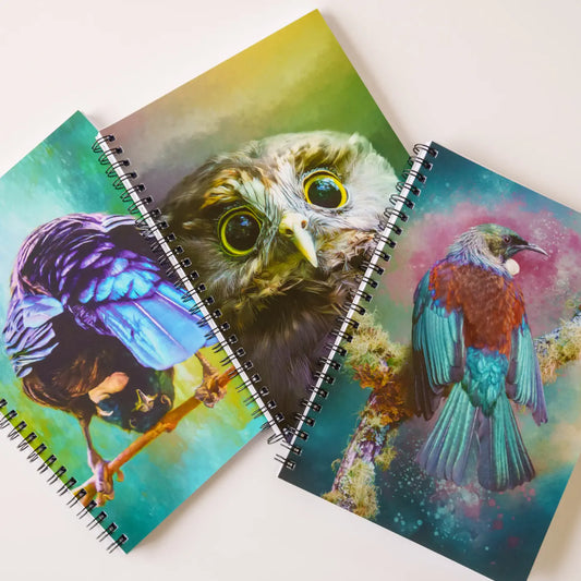 three notebooks with tui and ruru designs by Judi Lapsley Miller