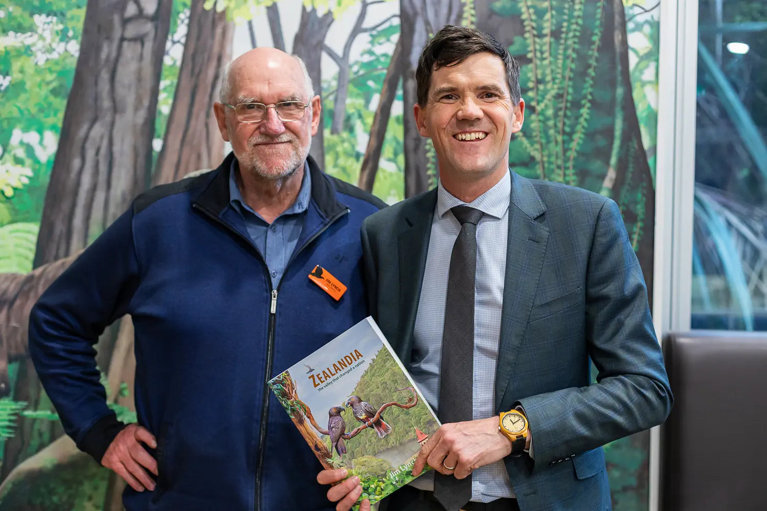 Jim Lynch and Justin Lester at the book launch holding the book with "Imagine" cover art.