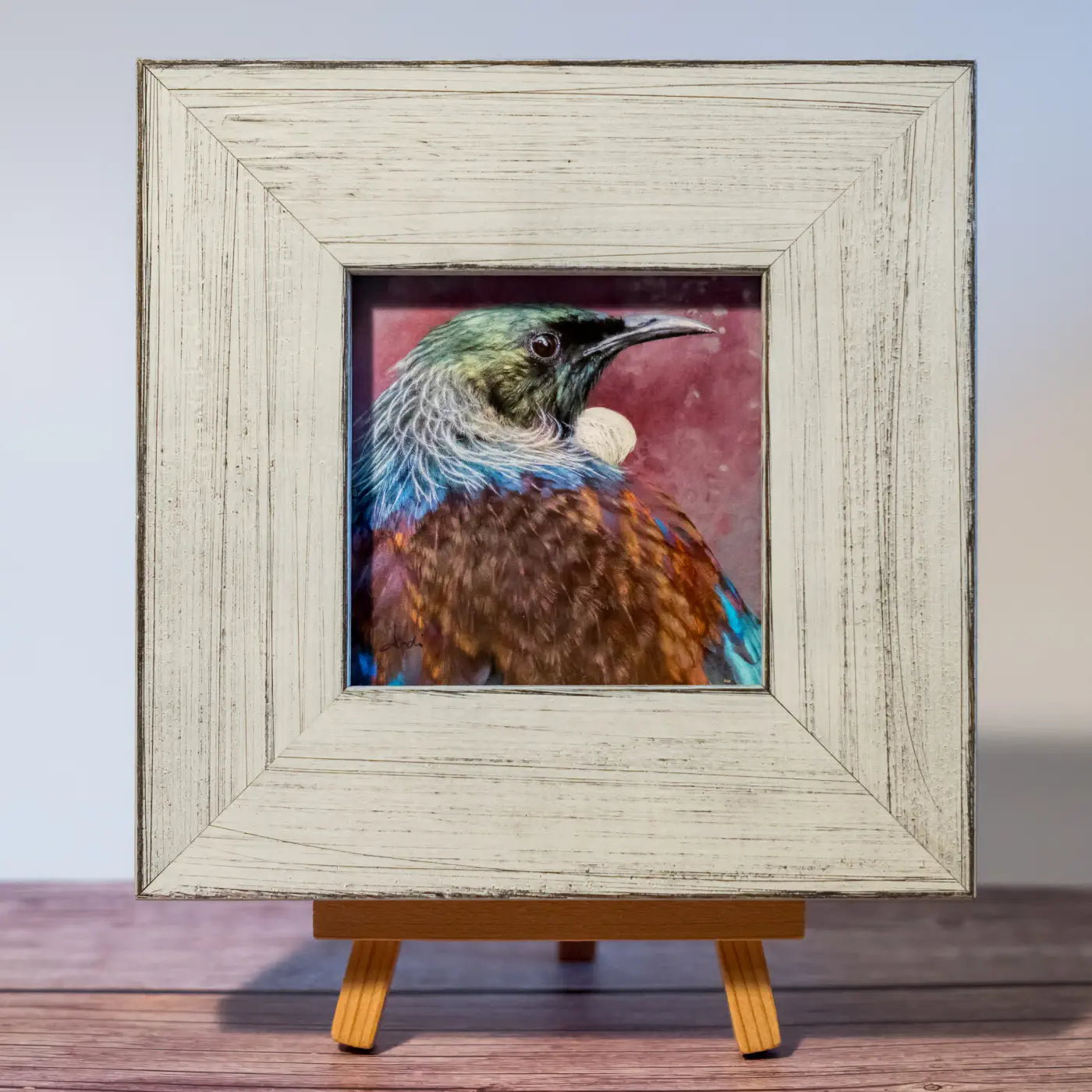 Tiny framed artwork of a tui