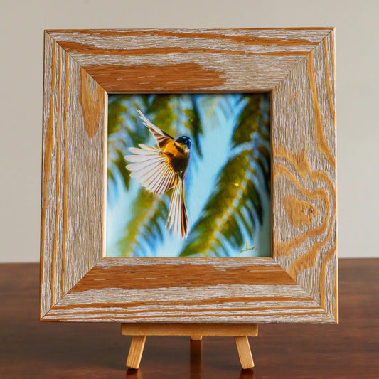 Wooden framed picture of a bird on a stand with a neutral background
