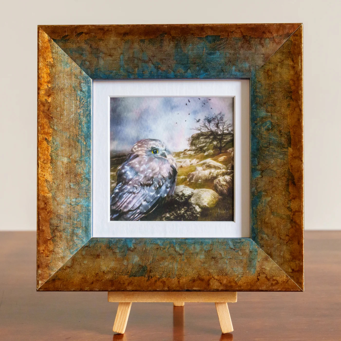 Framed artwork of a bird on a rock with a textured brown frame.