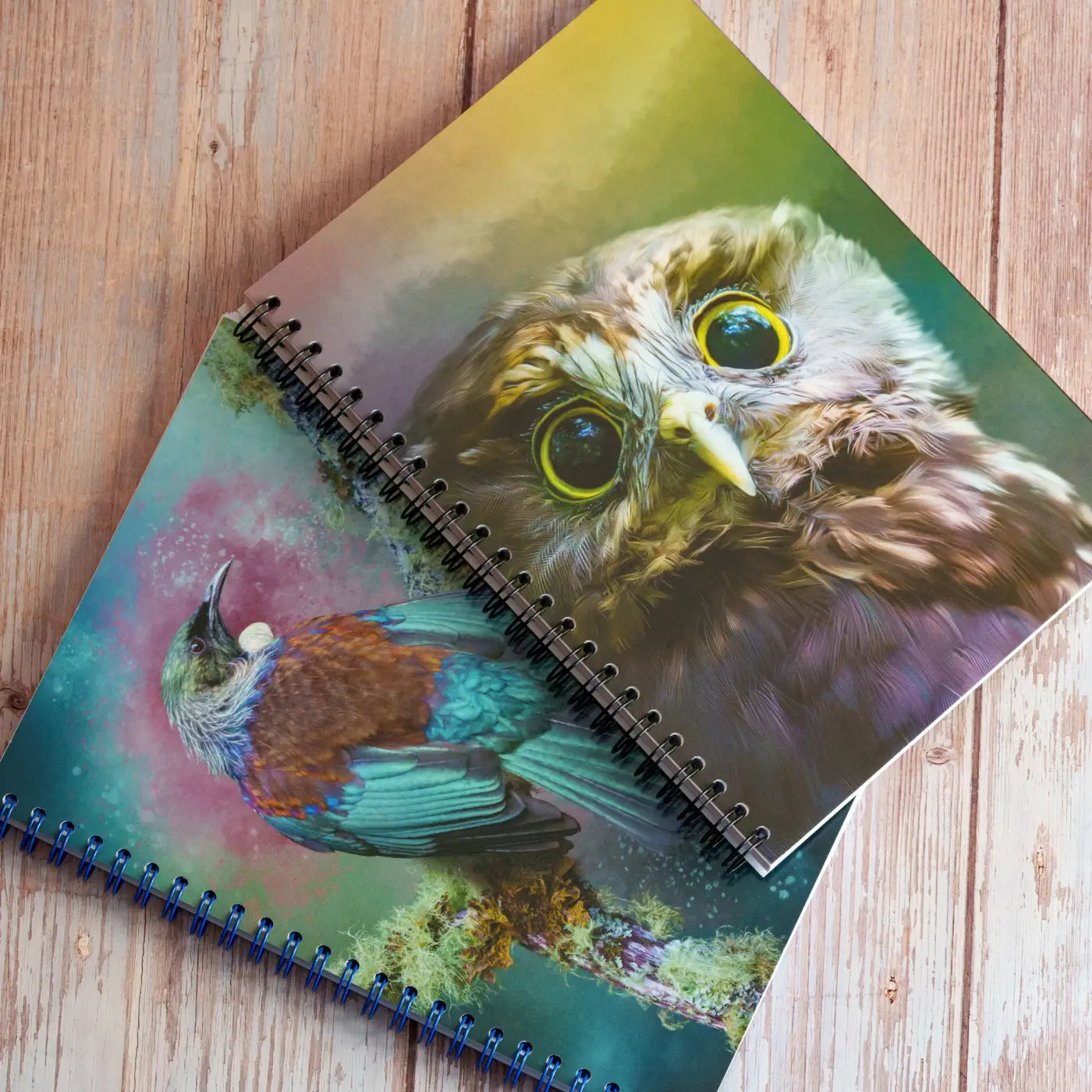 two notebooks with bird art on the covers