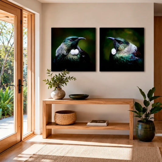 Two framed artworks of birds on a wall above a wooden console table with decorative items.