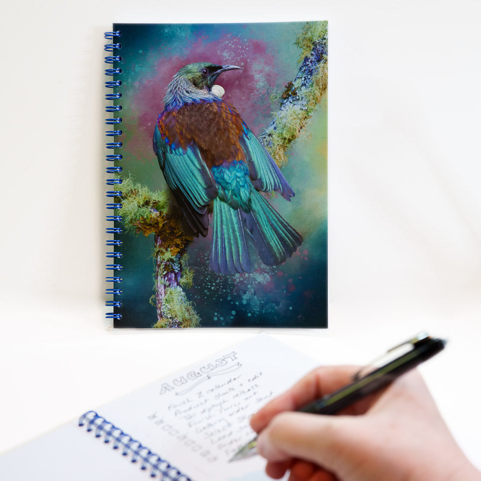 Tui notebook and hand writing a list