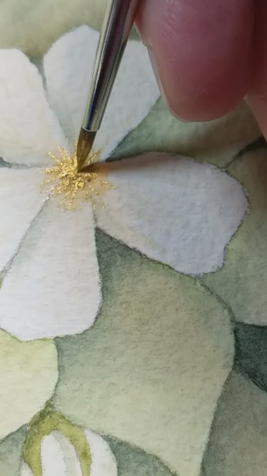 Hand embellishing the stames with gold watercolour paint and a tiny brush