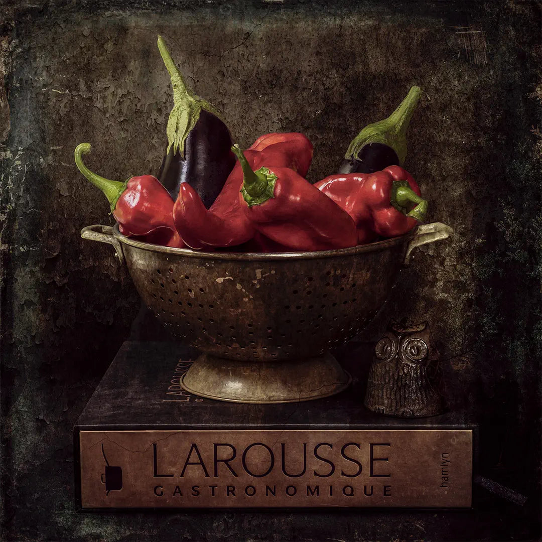 Artwork of a still life arrangement of capsicums or peppers and aubergines or eggplants in a copper colander on top of a cook book