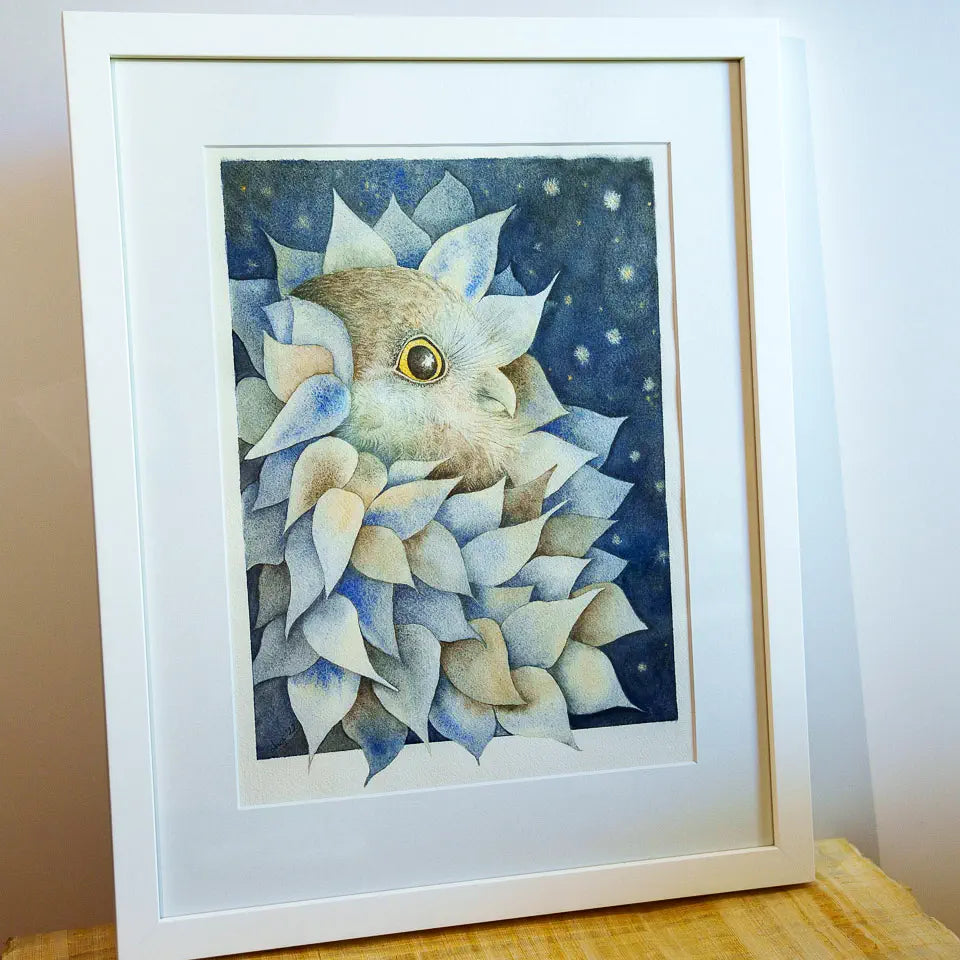 Framed artwork of an owl amongst leaves, angled view which shows the gold highlights better