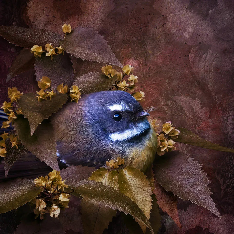 An artwork of a cute fantail or piwakawaka peeking out from akeake leaves and flower sepals with a tapestry or embroidered background