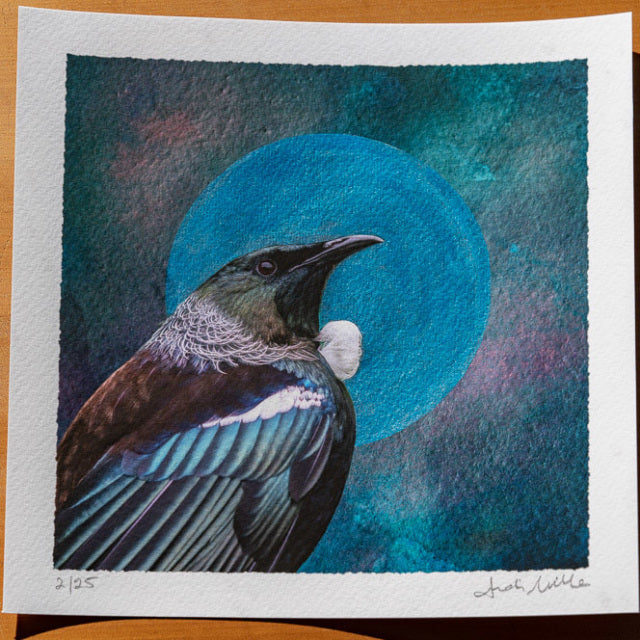 embellished print showing artwork of a tui with an blue pearlescent moon or halo surround it