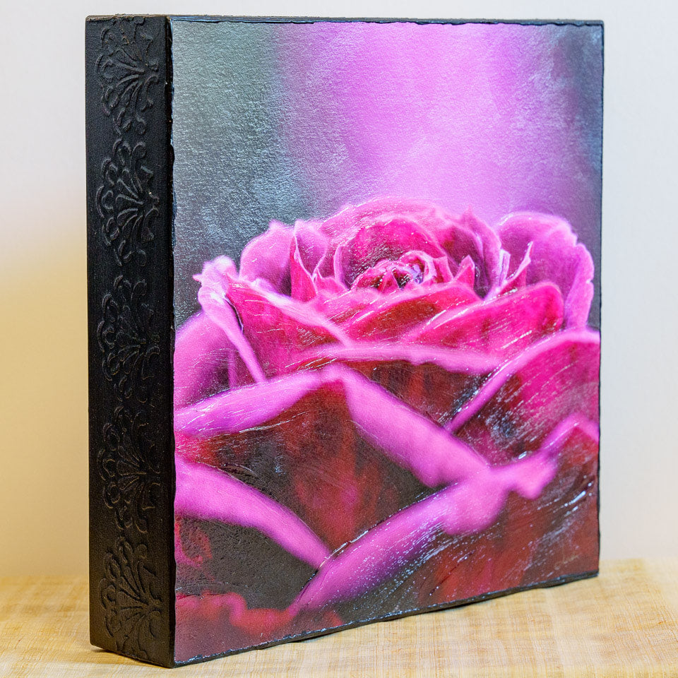 Photo of mounted print of pink and purple rose with an impasto finish - angled view showing embossed side of cradleboard and impasto brushwork