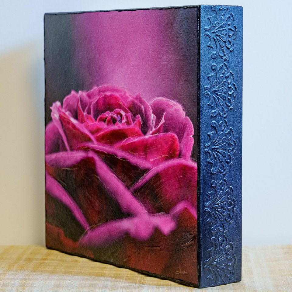 Photo of mounted print of pink and purple rose with an impasto finish - angled view showing embossed side of cradleboard and impasto brushwork